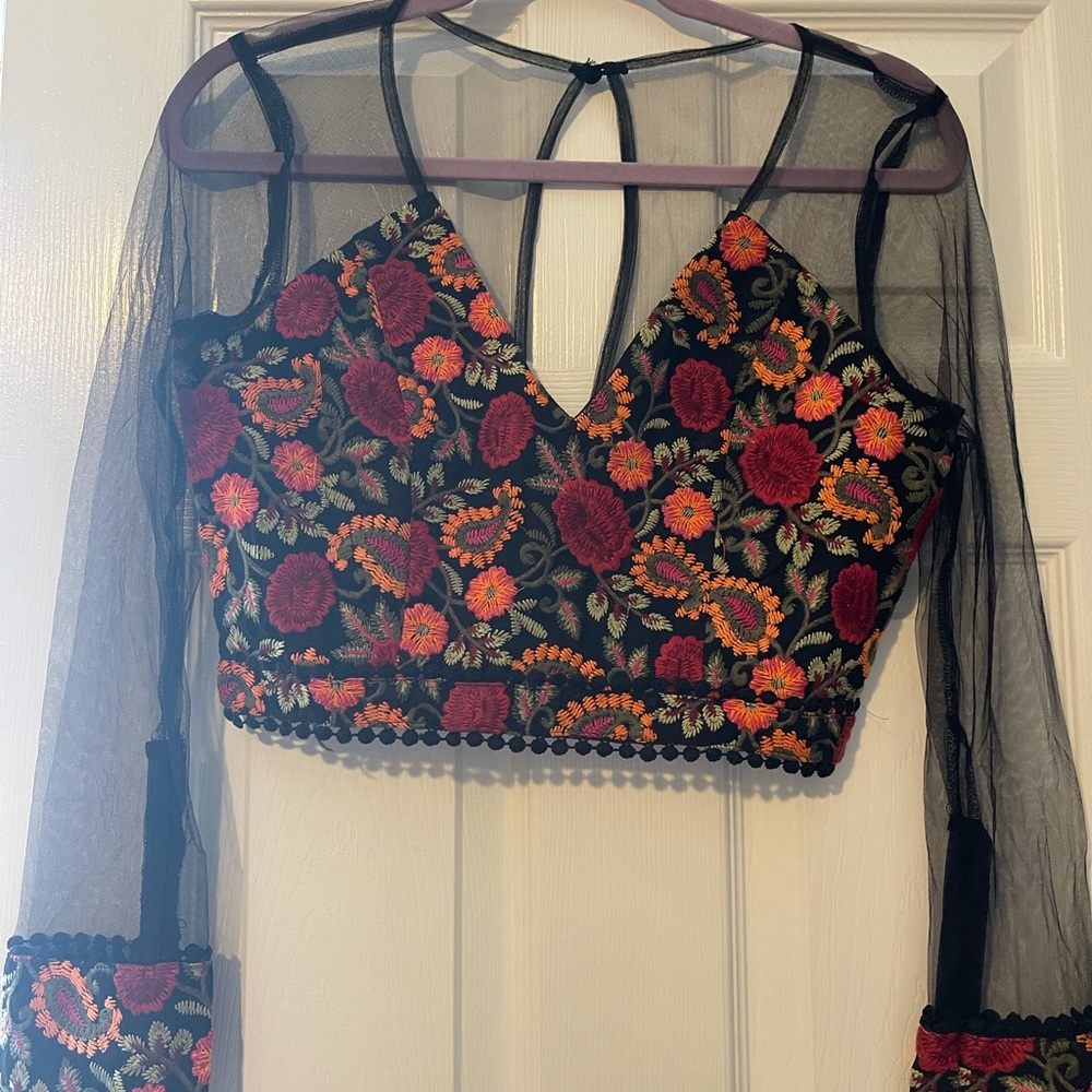 Long sleeve top with embroidered flowers.